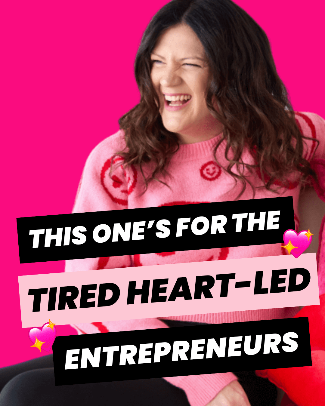 Emily sitting on a chair wearing a pink shirt with red smiley faces on it.