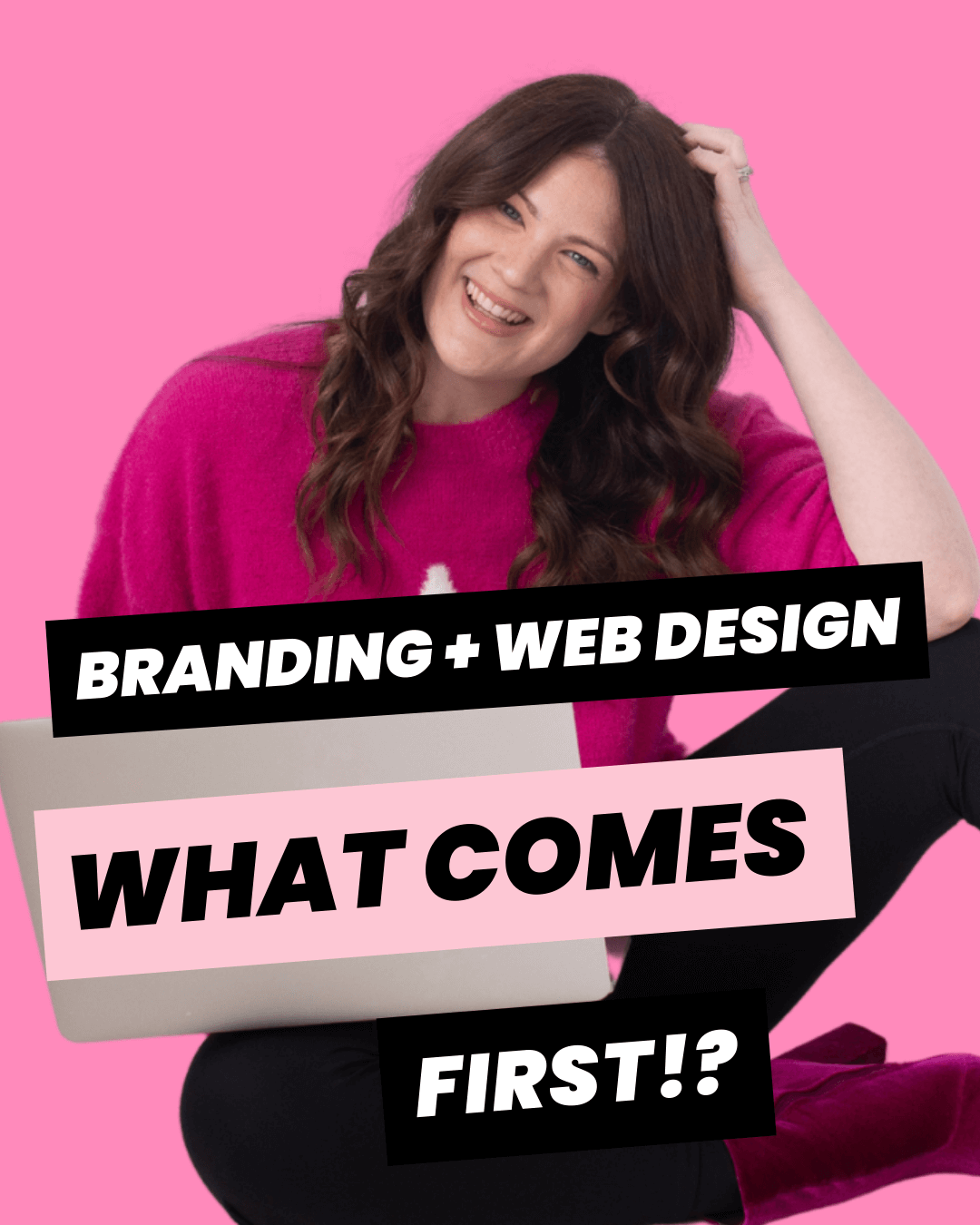 Emily Lauren Dick, brand identity designer, wearing a pink sweater and holding her lap top while smiling